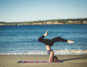 Frau macht Yoga am Strand.