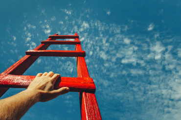 Symbolbild: Eine rote Leiter führt in den Himmel.