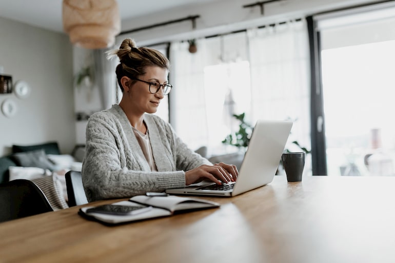 Geschäftsfrau arbeitet im Homeoffice konzentriert am Laptop