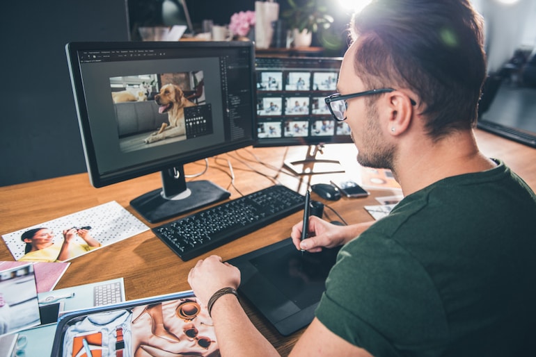 Fotograf bearbeitet Bilder am Computer